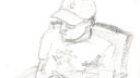 Un homme utilise un crayon pour dessiner une figure humaine sur un cahier